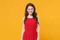 Smiling attractive young brunette woman girl in red summer dress posing  on yellow background studio portrait Royalty Free Stock Photo