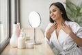 Smiling attractive young indian woman looking at mirror Royalty Free Stock Photo