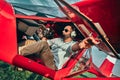 Smiling attractive young man pilot sitting in cabin preparing for take off of small aircraft Royalty Free Stock Photo