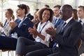 Smiling audience applauding at a business seminar Royalty Free Stock Photo
