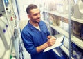 Smiling auto mechanic with clipboard at car shop Royalty Free Stock Photo