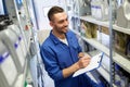 Smiling auto mechanic with clipboard at car shop Royalty Free Stock Photo