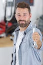 smiling auto mechanic with wrench standing Royalty Free Stock Photo