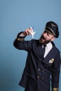 Smiling aviator in uniform holding airplane model