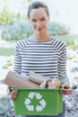 Smiling woman segregating paper junk