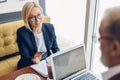 Smiling awesome blond woman explaining her business idea