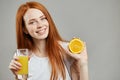 Smiling awesome girl drinking orange juice