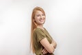 A smiling awesome young red-haired girl in green T-shirt