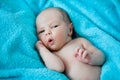 Smiling baby on a blue blanket