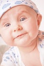 Smiling baby in a blue cap Royalty Free Stock Photo