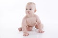 Smiling baby-boy in a diaper crawling on the floor Royalty Free Stock Photo