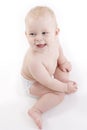 Smiling baby-boy in a diaper sitting on the floor Royalty Free Stock Photo