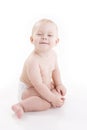 Smiling baby-boy in a diaper sitting on the floor Royalty Free Stock Photo