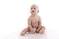 Smiling baby-boy in a diaper sitting on the floor Royalty Free Stock Photo