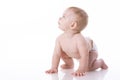 Smiling baby-boy in a diaper sitting on the floor