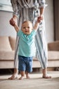 Smiling baby boy making first steps with mother Royalty Free Stock Photo
