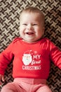 Smiling baby boy in red pullover lying on bed. Close top view Royalty Free Stock Photo