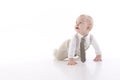 Smiling baby-boy in a romper suit crawling