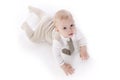 Smiling baby-boy in a romper suit crawling Royalty Free Stock Photo