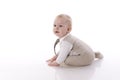 Smiling baby-boy in a romper suit crawling Royalty Free Stock Photo