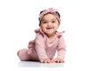 Smiling baby crawling on studio floor. Royalty Free Stock Photo