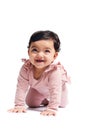 Smiling baby crawling on studio floor. Royalty Free Stock Photo