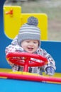 Smiling baby driving car on playground Royalty Free Stock Photo