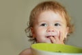 Smiling baby eating food. Healthy nutrition for kids. Funny child face closeup. Royalty Free Stock Photo
