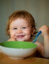 Smiling baby eating food. Launching child eat. Royalty Free Stock Photo