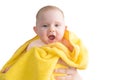 Smiling baby girl after bathing wrapped in a yellow towel Royalty Free Stock Photo