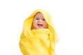 Smiling baby girl after bathing wrapped in a yellow towel Royalty Free Stock Photo