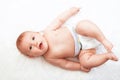 Smiling Baby Girl are Lying in the Bed Royalty Free Stock Photo