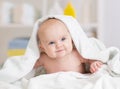 Smiling baby girl lying under towel Royalty Free Stock Photo