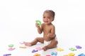 Smiling Baby Girl Playing with Letter Toys