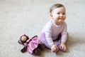 Smiling baby girl plays with toy bear Royalty Free Stock Photo