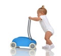 Smiling baby girl toddler with toy walker make first steps Royalty Free Stock Photo