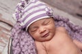 Smiling Baby Girl Wearing a Sleeping Cap