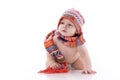 Smiling baby in knitted hat and scarf