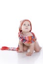 Smiling baby in knitted hat and scarf