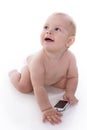 Smiling baby is learning to deal with a phone Royalty Free Stock Photo