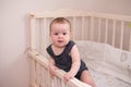 Smiling baby looking at camera and smilling , child in her bed Royalty Free Stock Photo