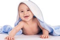 Smiling baby lying on bed under towel Royalty Free Stock Photo