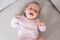 Smiling baby lying on sofa in living room Royalty Free Stock Photo