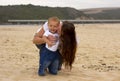 Smiling baby with mother on beach