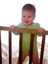 Smiling baby at the nursery room cot Royalty Free Stock Photo