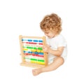 Smiling baby playing with abacus. Royalty Free Stock Photo