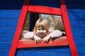 Smiling baby portrait at wooden window Royalty Free Stock Photo