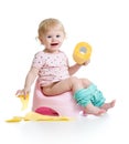 Smiling baby sitting on chamber pot Royalty Free Stock Photo