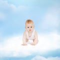 Smiling baby sitting on the cloud Royalty Free Stock Photo