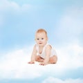 Smiling baby sitting on the cloud Royalty Free Stock Photo